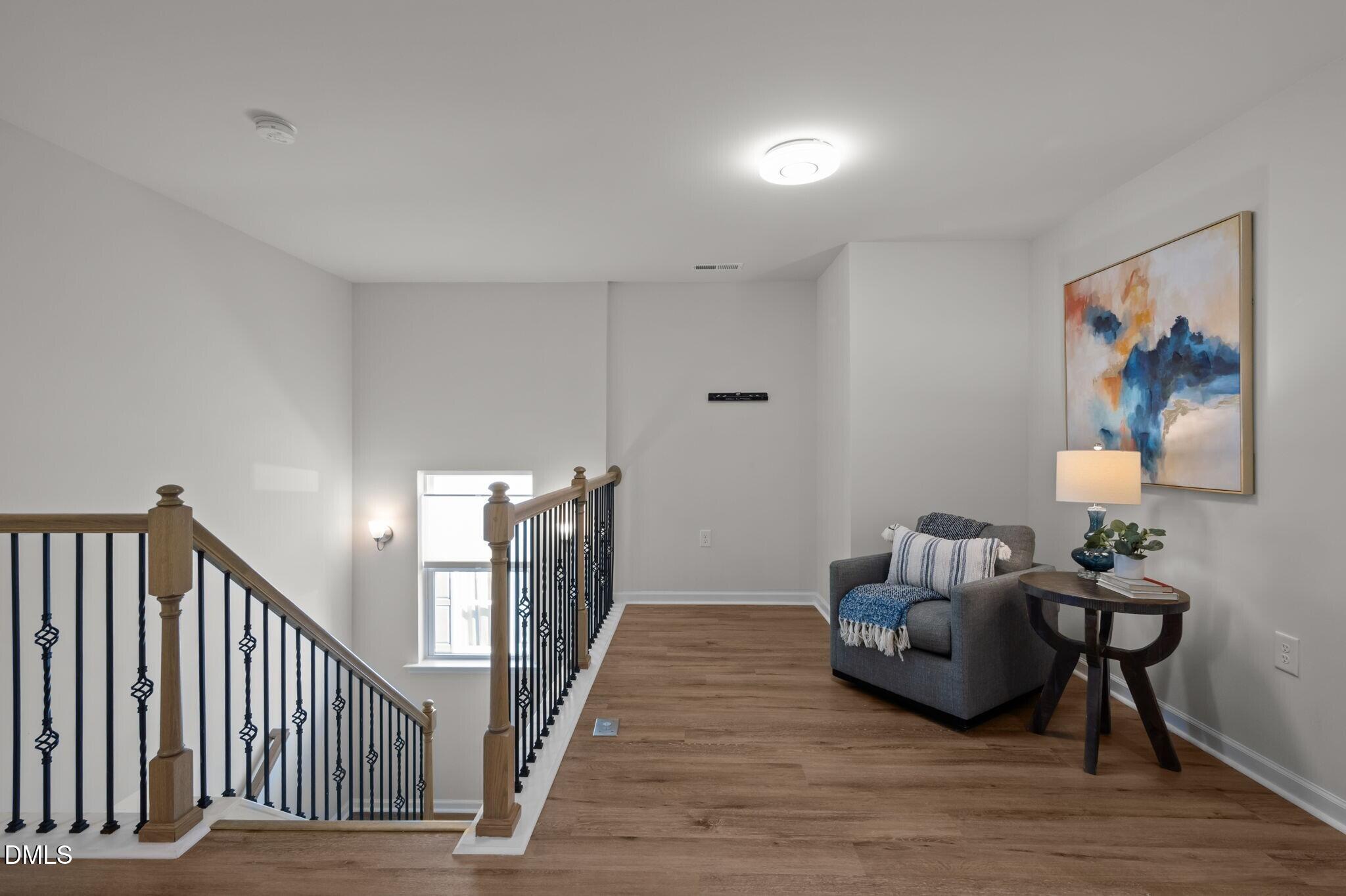 17 Rambler Lane Morrisville, NC 27560 - Photo 20 of 50 a view of a hallway with wooden floor and stairs