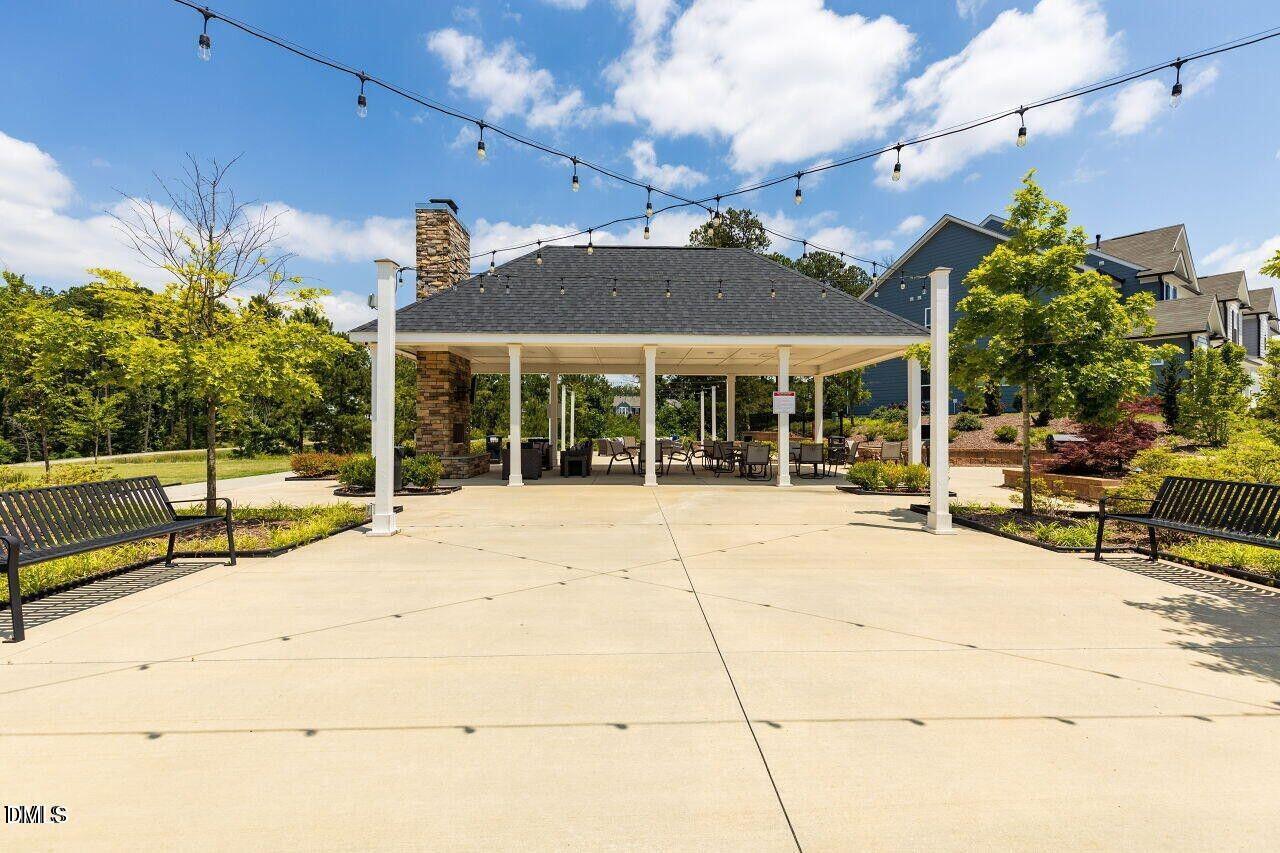 17 Rambler Lane Morrisville, NC 27560 - Photo 40 of 50 a view of a patio with a table and chairs under an umbrella
