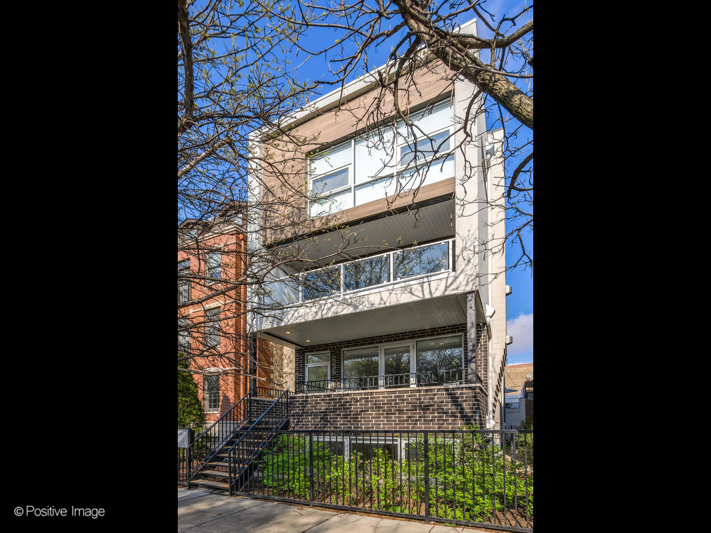 a view of house with a tree in front of it