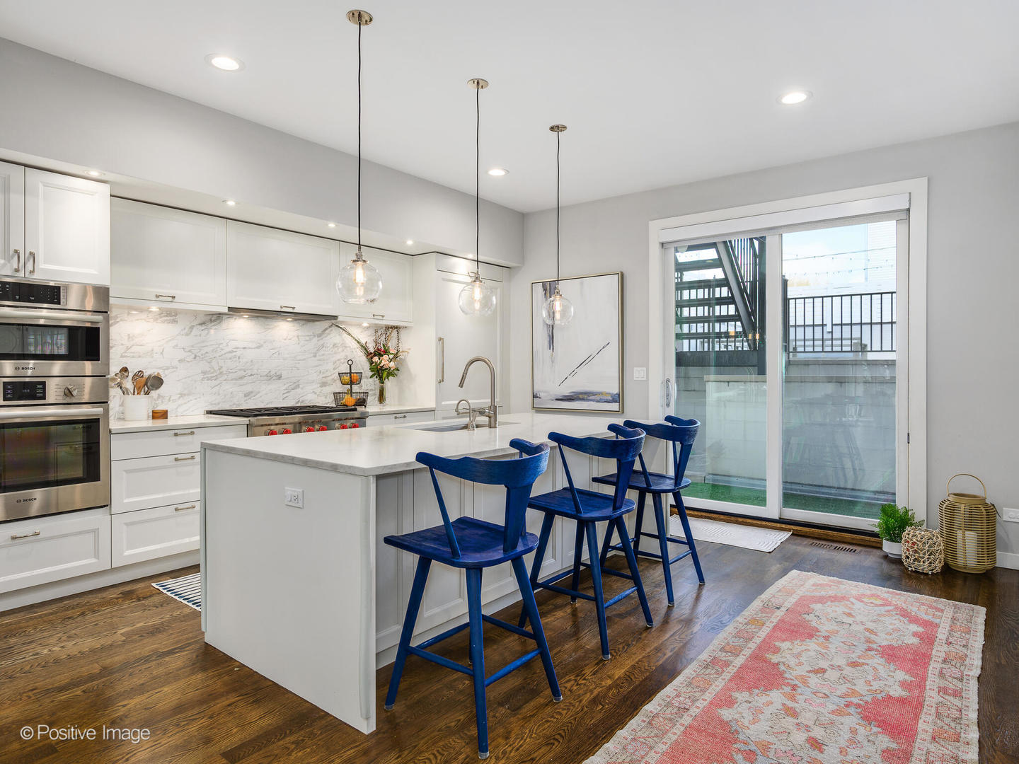 2235 North Oakley Avenue, Unit 1 Chicago, IL 60647 - Photo 11 of 27 a kitchen with stainless steel appliances granite countertop a stove a sink a microwave a refrigerator and wooden floor