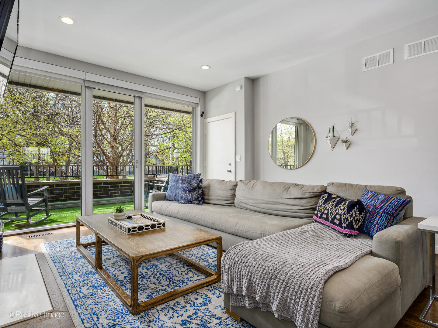 2235 North Oakley Avenue, Unit 1 Chicago, IL 60647 - Photo 2 of 27 a living room with a couch a table and a large window