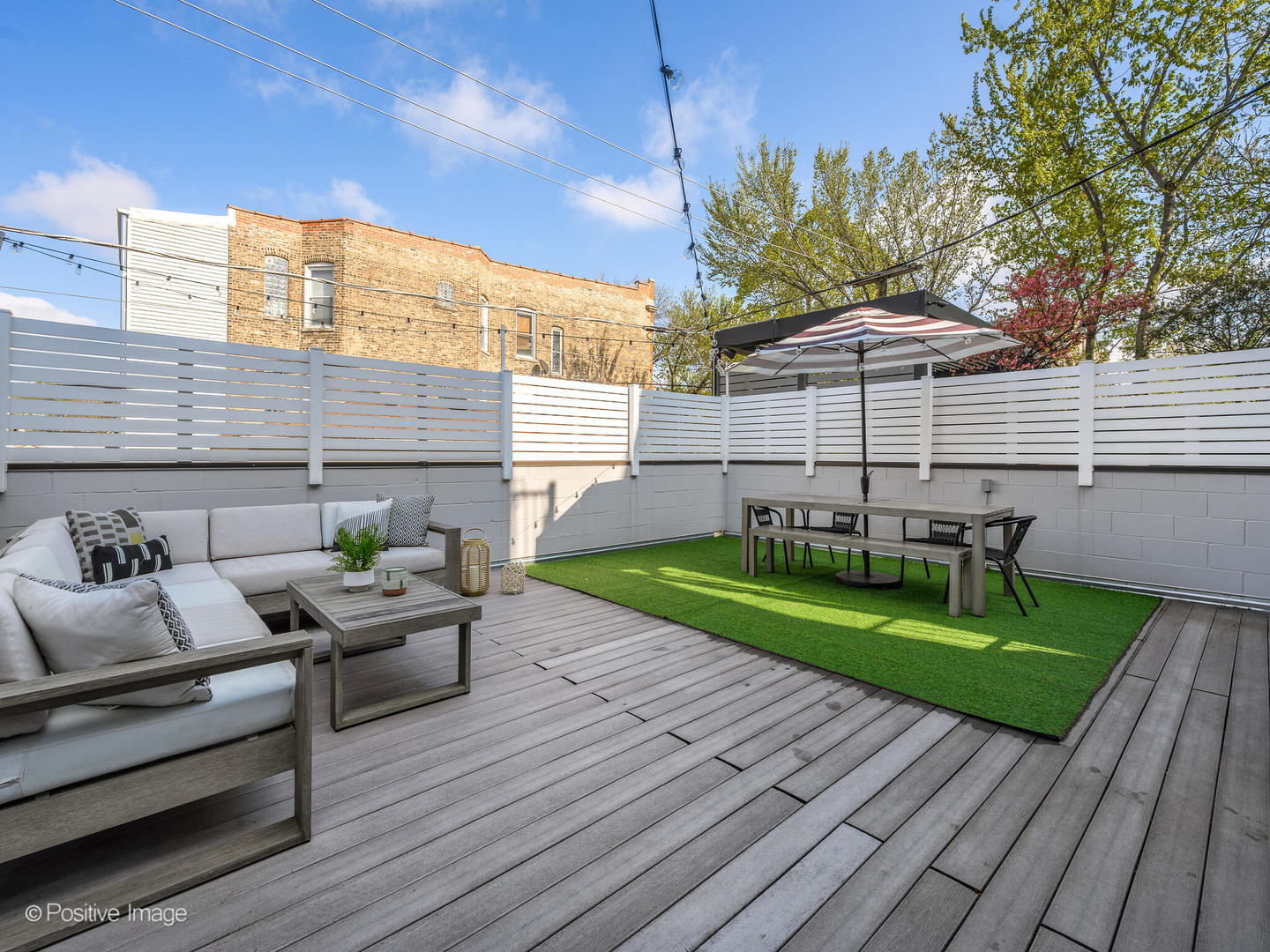 2235 North Oakley Avenue, Unit 1 Chicago, IL 60647 - Photo 24 of 27 a view of a patio with couches chairs potted plants and wooden floor