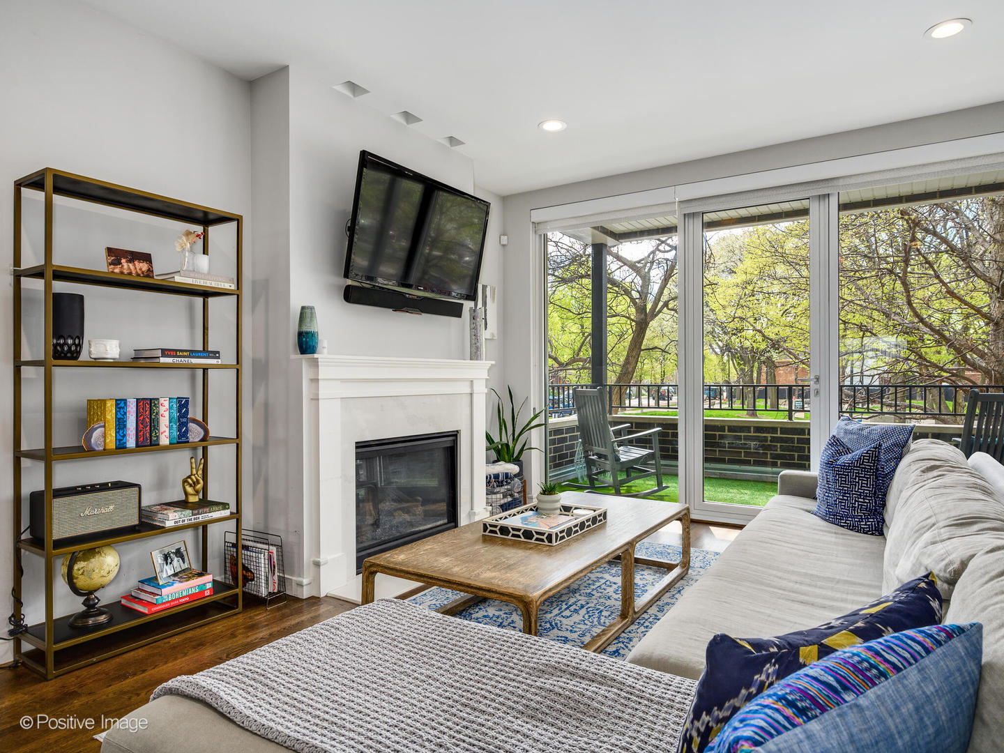 2235 North Oakley Avenue, Unit 1 Chicago, IL 60647 - Photo 4 of 27 a living room with furniture a flat screen tv and a fireplace