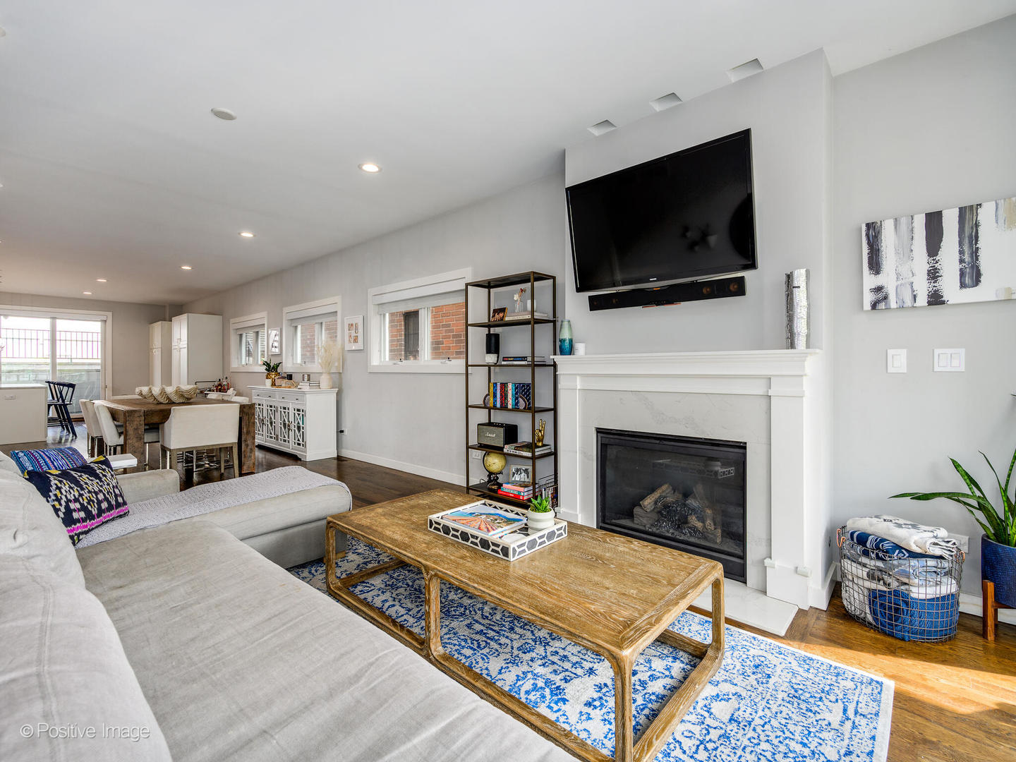 2235 North Oakley Avenue, Unit 1 Chicago, IL 60647 - Photo 5 of 27 a living room with furniture a flat screen tv and a fireplace