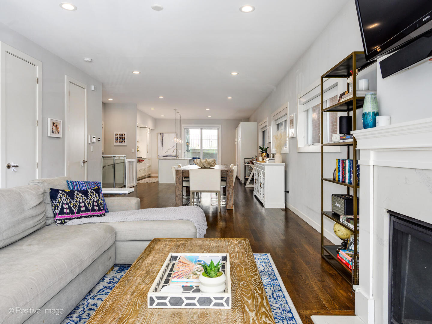 2235 North Oakley Avenue, Unit 1 Chicago, IL 60647 - Photo 6 of 27 a living room with furniture fireplace and a table