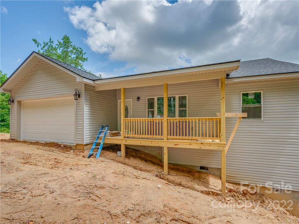 39 Hamilton Acrs Drive Tryon, NC 28782 - Photo 1 of 25 a view of a house with a wooden deck and a yard