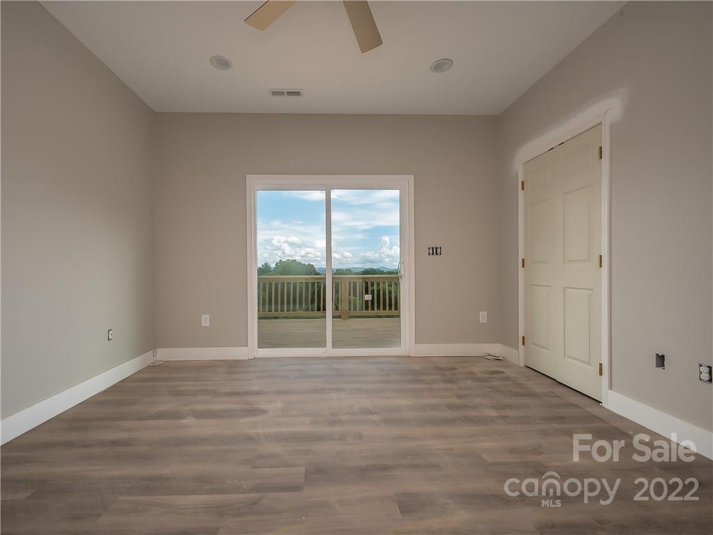 39 Hamilton Acrs Drive Tryon, NC 28782 - Photo 11 of 25 a view of an empty room with wooden floor and a window