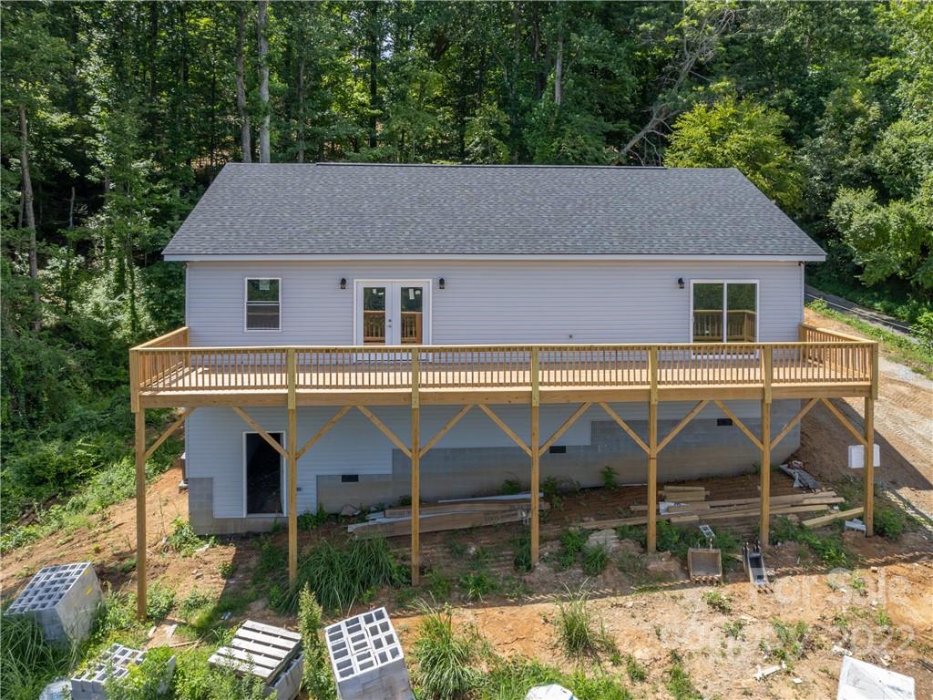 39 Hamilton Acrs Drive Tryon, NC 28782 - Photo 23 of 25 a view of a blue house with large trees next to a yard