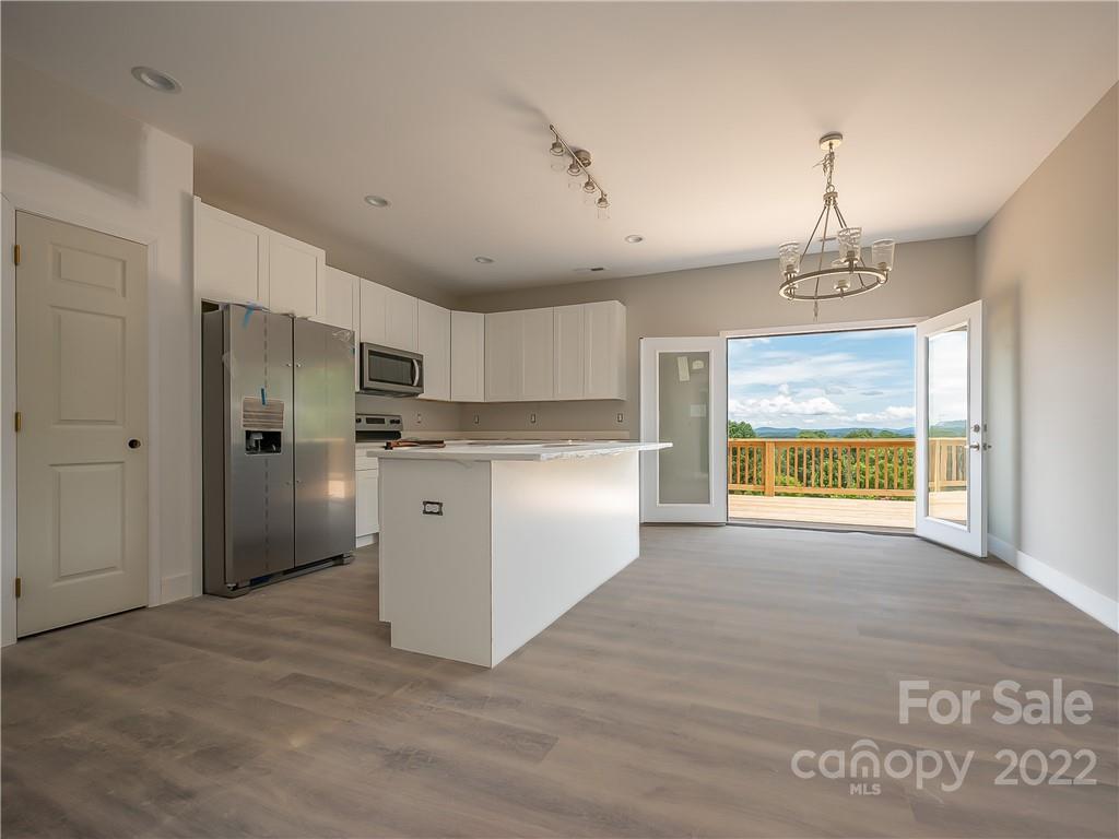 39 Hamilton Acrs Drive Tryon, NC 28782 - Photo 5 of 25 a kitchen with stainless steel appliances granite countertop a stove a refrigerator and a sink