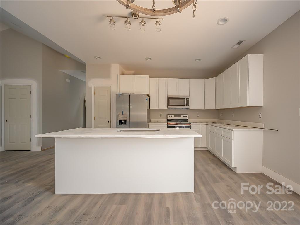39 Hamilton Acrs Drive Tryon, NC 28782 - Photo 7 of 25 a kitchen with stainless steel appliances a refrigerator sink and cabinets