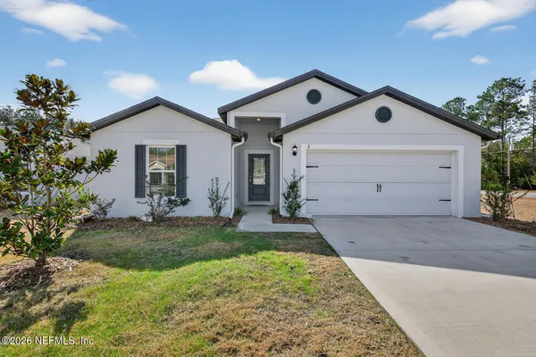 a view of a house with a yard and garage