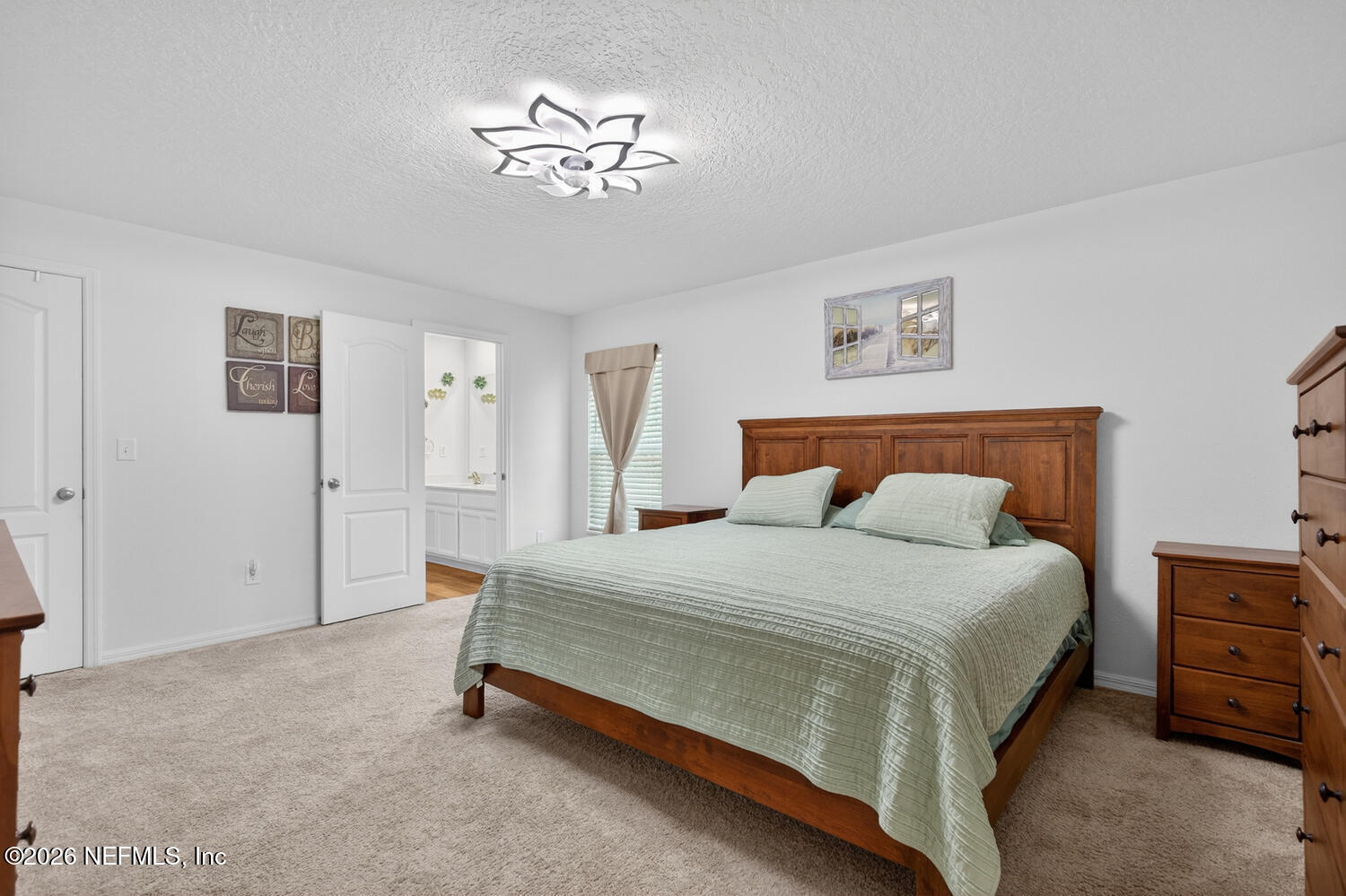 2 Radium Lane Palm Coast, FL 32164 - Photo 11 of 22 a bedroom with a bed and a chandelier