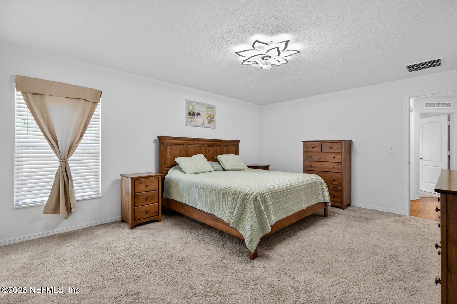 2 Radium Lane Palm Coast, FL 32164 - Photo 12 of 22 a bedroom with a bed and a chandelier