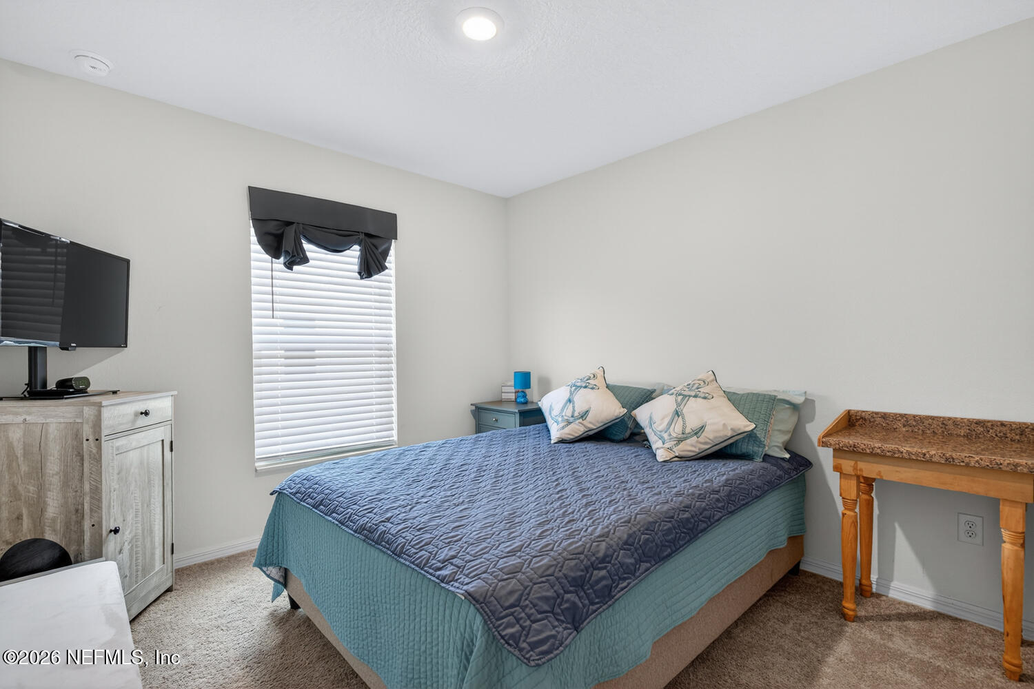 2 Radium Lane Palm Coast, FL 32164 - Photo 16 of 22 a bedroom with a bed and a flat screen tv