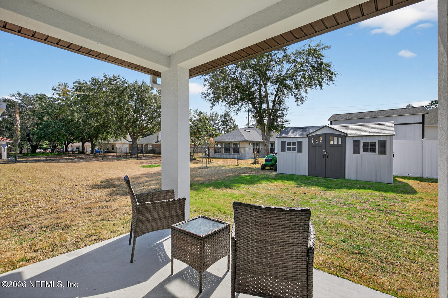 2 Radium Lane Palm Coast, FL 32164 - Photo 22 of 22 a view of a patio with table and chairs next to a yard