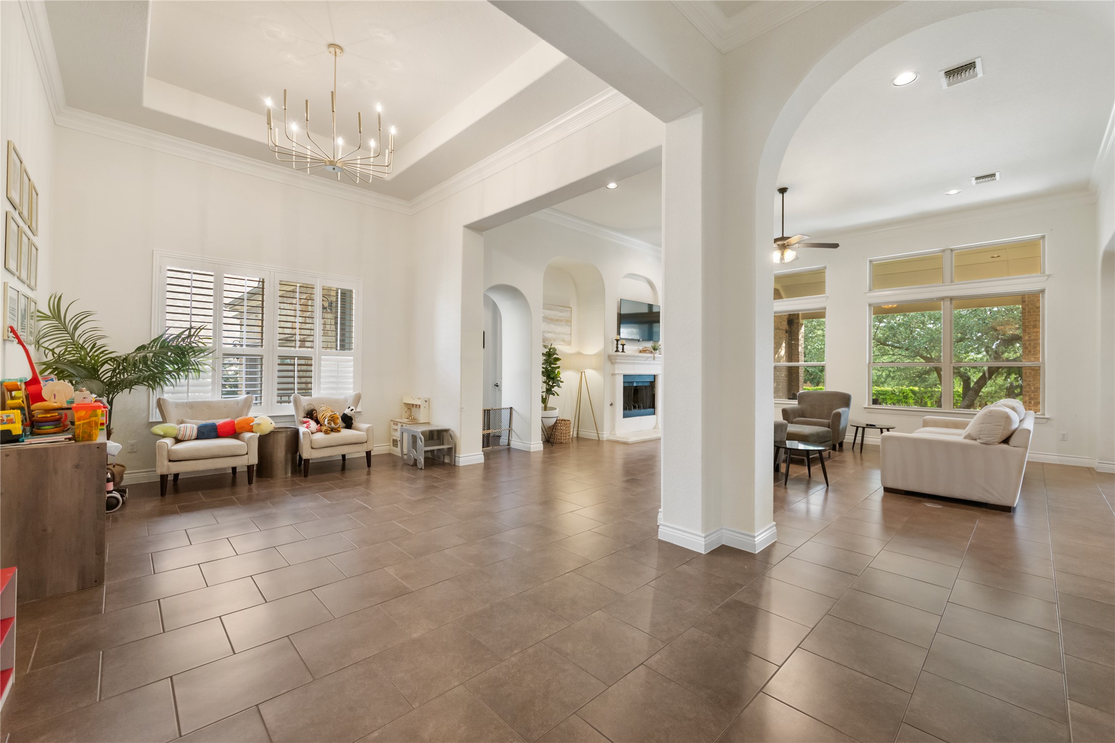415 Bitterroot Lane Austin, TX 78737 - Photo 25 of 25 The expansive open floorplan flows seamlessly, illuminated by a contemporary chandelier and natural light.