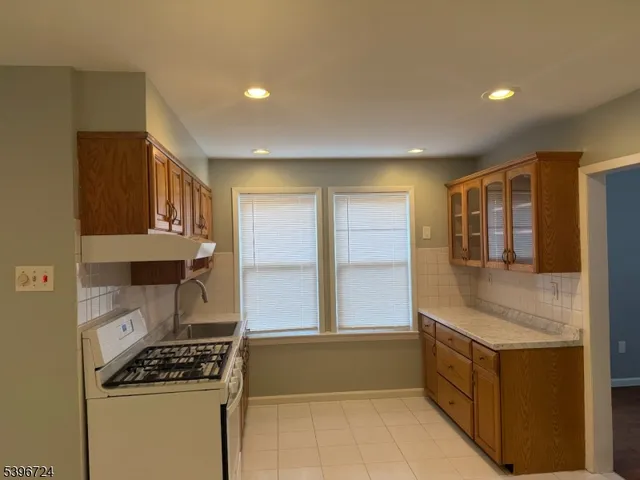 a kitchen with stainless steel appliances granite countertop a stove and a refrigerator