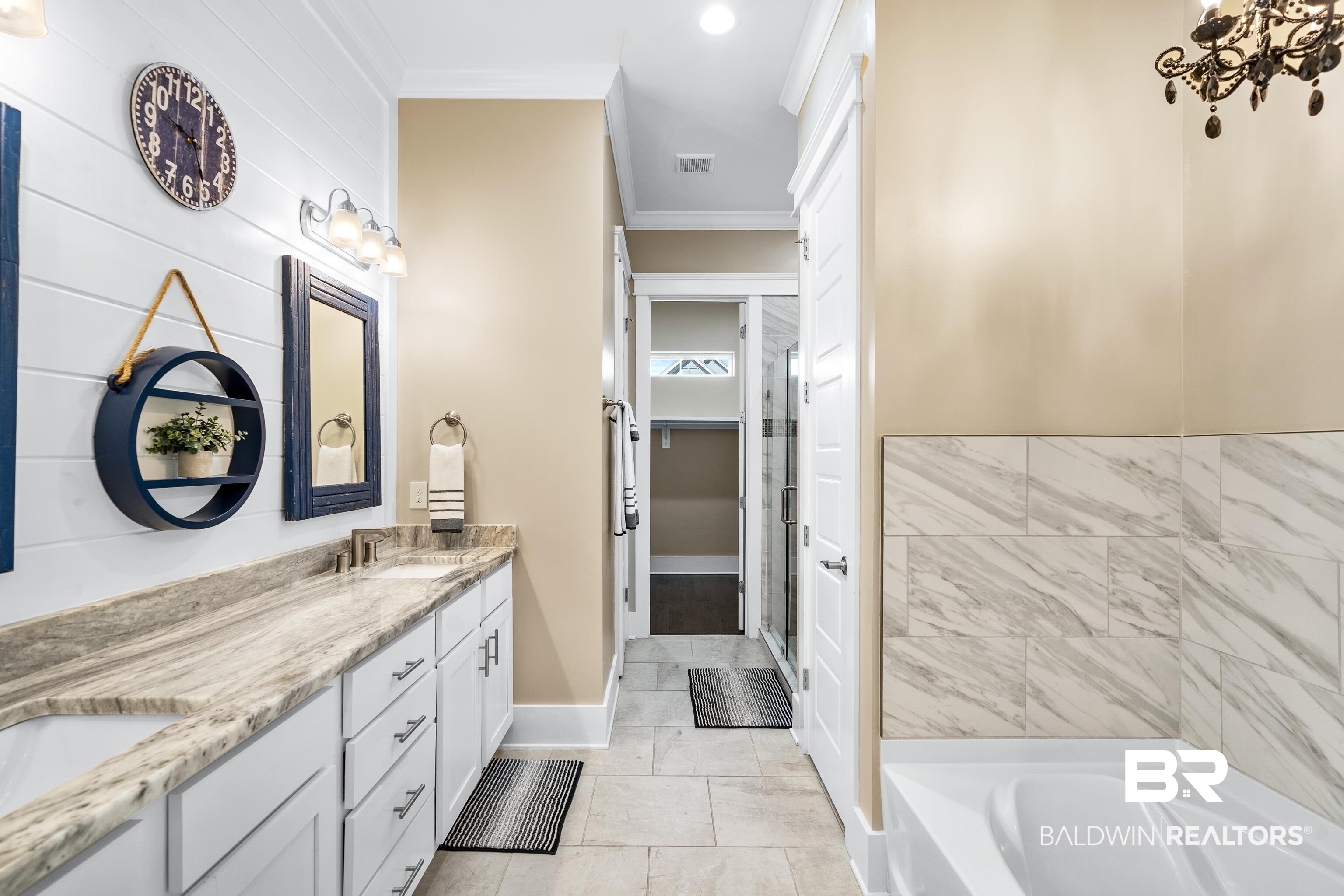 1018 Snapdragon Lane Foley, AL 36535 - Photo 24 of 37 Bathroom with crown molding, a washtub, vanity, and tile patterned flooring