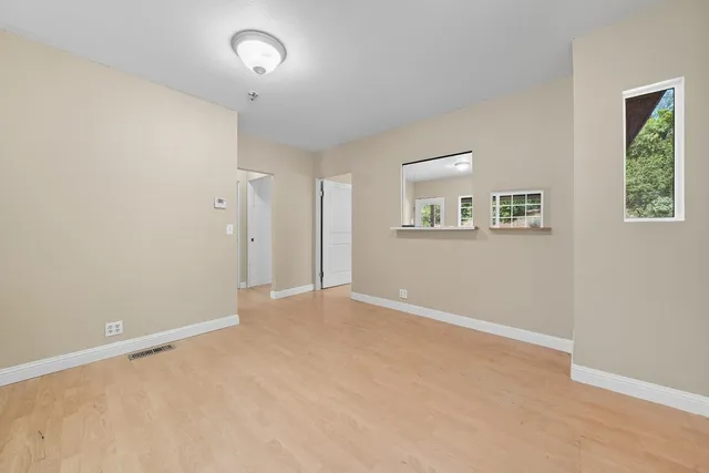 an empty room with windows and closet