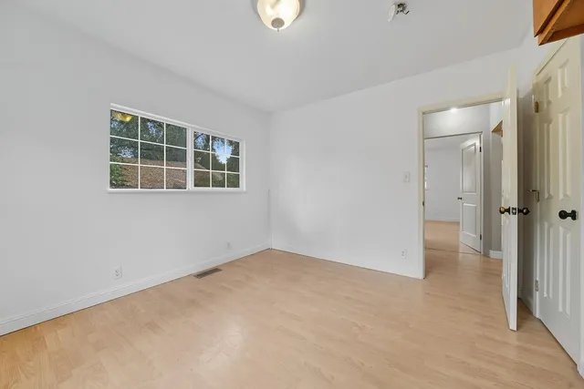 an empty room with windows and entrance