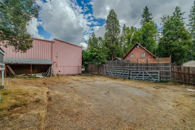 a view of a house with wooden fence