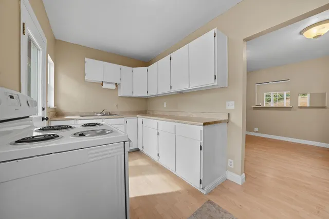 a kitchen with appliances cabinets and a sink
