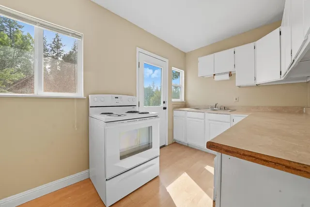 a utility room with sink dryer and washer