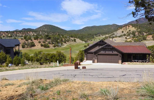 a view of a lush green hillside and houses