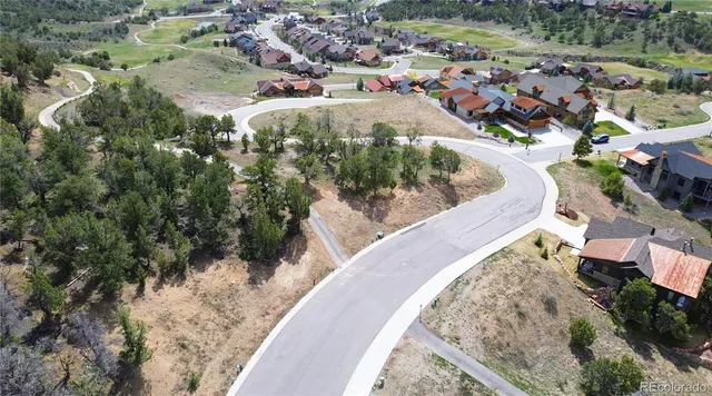 an aerial view of residential house and sandy dunes
