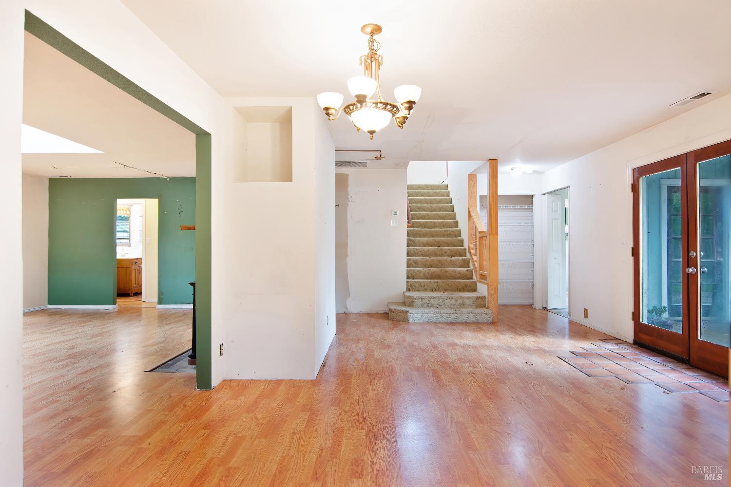 700 Cecelia Drive Glen Ellen, CA 95442 - Photo 6 of 13 a view of a hallway with wooden floor and a chandelier