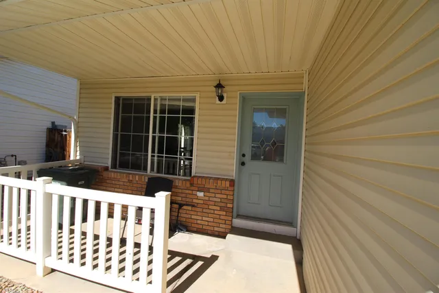 a view of a porch with wooden floor and fence