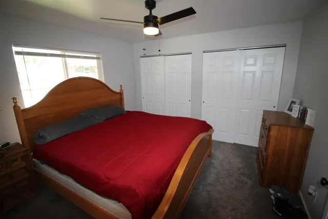 a bedroom with a bed and chair