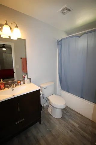 a bathroom with a sink vanity mirror and toilet