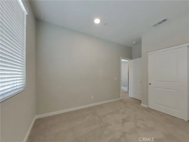 an empty room with a empty space and windows