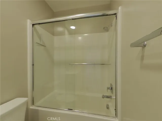 a bathroom with a glass shower door