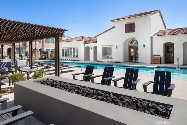 a view of a patio with couches table and chairs and potted plants
