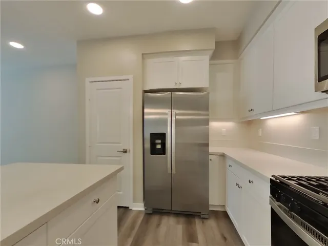 a kitchen with a refrigerator and a stove