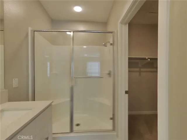 a bathroom with a shower and a sink