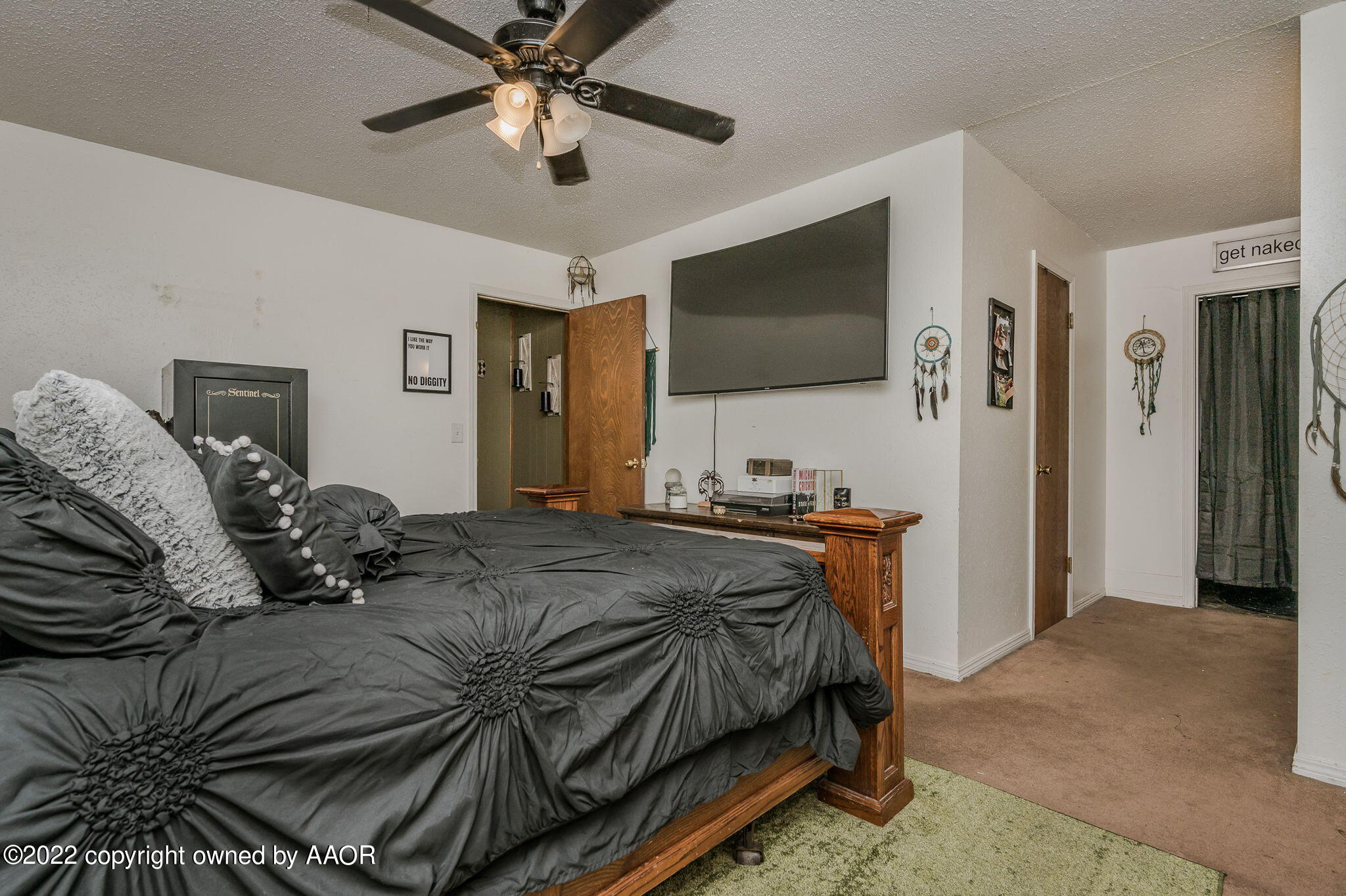 5110 Shawnee Trail Amarillo, TX 79109 - Photo 13 of 22 a bedroom with a bed and a flat screen tv