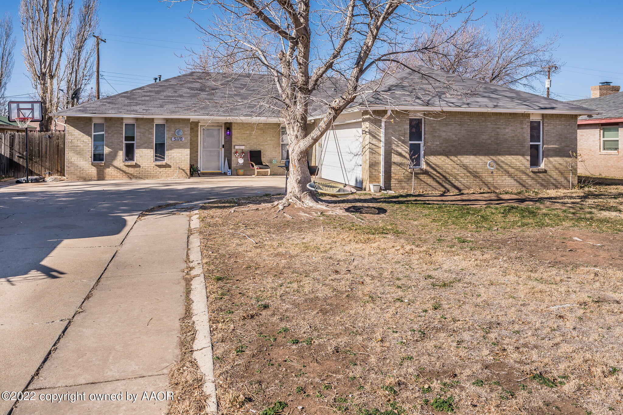 5110 Shawnee Trail Amarillo, TX 79109 - Photo 2 of 22 a view of a white house with large trees and playing area