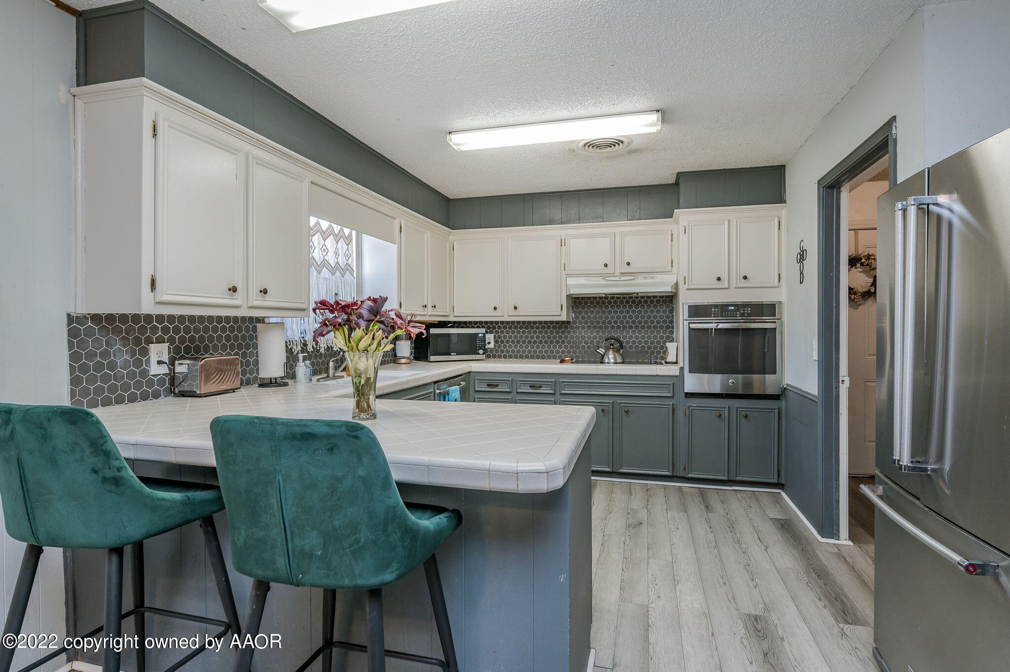 5110 Shawnee Trail Amarillo, TX 79109 - Photo 9 of 22 a kitchen with kitchen island granite countertop a table chairs microwave and cabinets