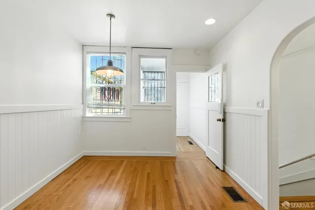 a kitchen with stainless steel appliances granite countertop a stove a sink dishwasher and a refrigerator with wooden cabinets