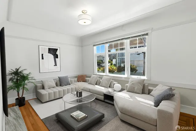 a view of a room with wooden floor and a window