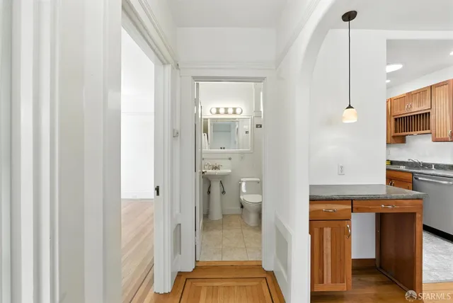 a bathroom with a toilet sink and mirror