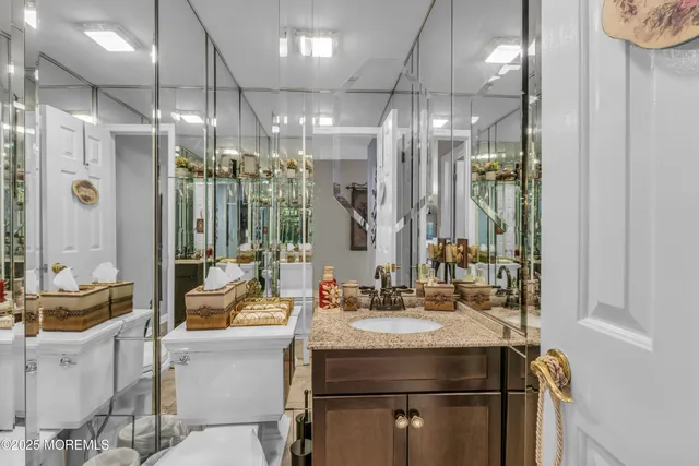 a living room with furniture a refrigerator and cabinets