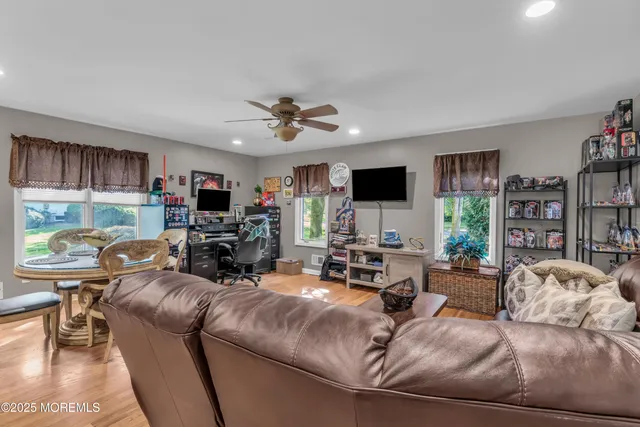 a kitchen with granite countertop a refrigerator a stove a sink dishwasher with a dining table and chairs