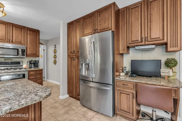 a kitchen with stainless steel appliances granite countertop a sink and cabinets