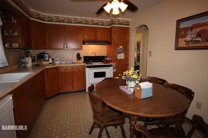 7559 West Dublin Road Freeport, IL 61032 - Photo 9 of 22 a kitchen with a dining table chairs and stove