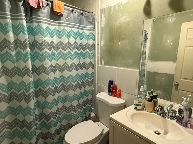 a bathroom with a sink toilet and shower