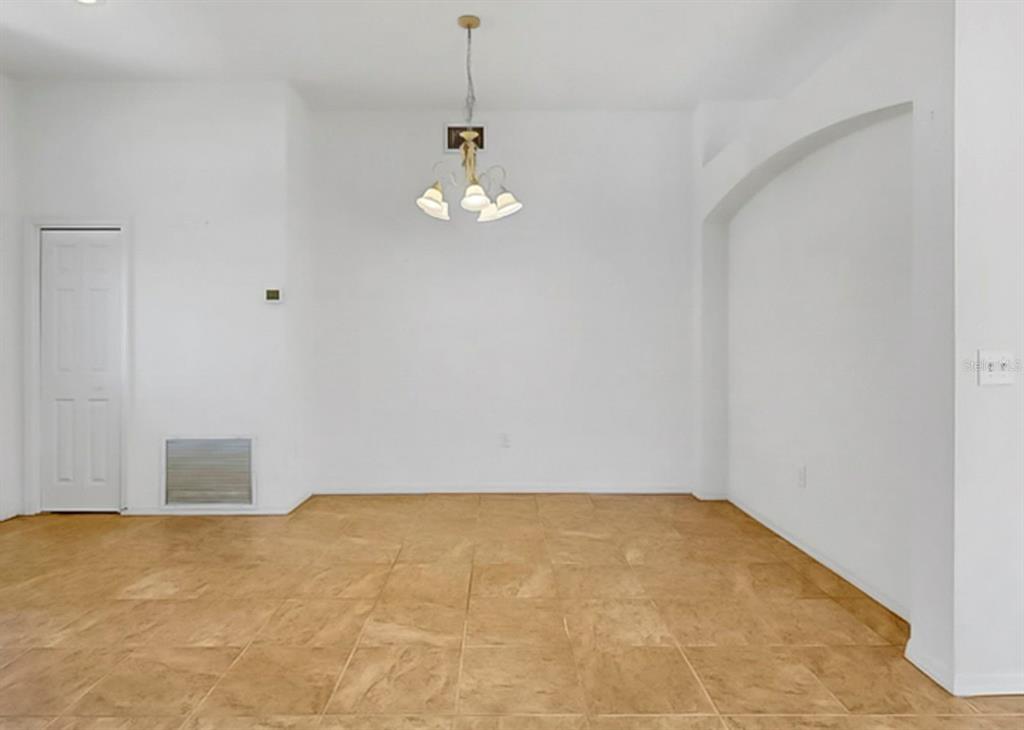 10725 Deepbrook Drive Riverview, FL 33569 - Photo 13 of 67 a view of empty room with wooden floor and stove